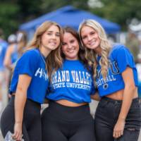 Students pose for a picture wearing GVSU shirts.